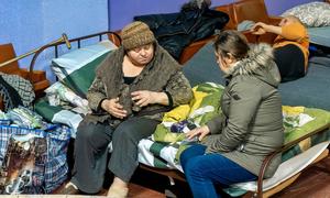 Women talk at a centre in Ukraine for people displaced by the war.