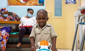 A two-year-old boy diagnosed with leukemia and treated with chemotherap plays while he waits to see a doctor at a hospital in Ghana.