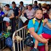 Imigrantes e refugiados venezuelanos fazem fila em Pacaraima, uma cidade no norte do Brasil que fica do outro lado da fronteira com a Venezuela.