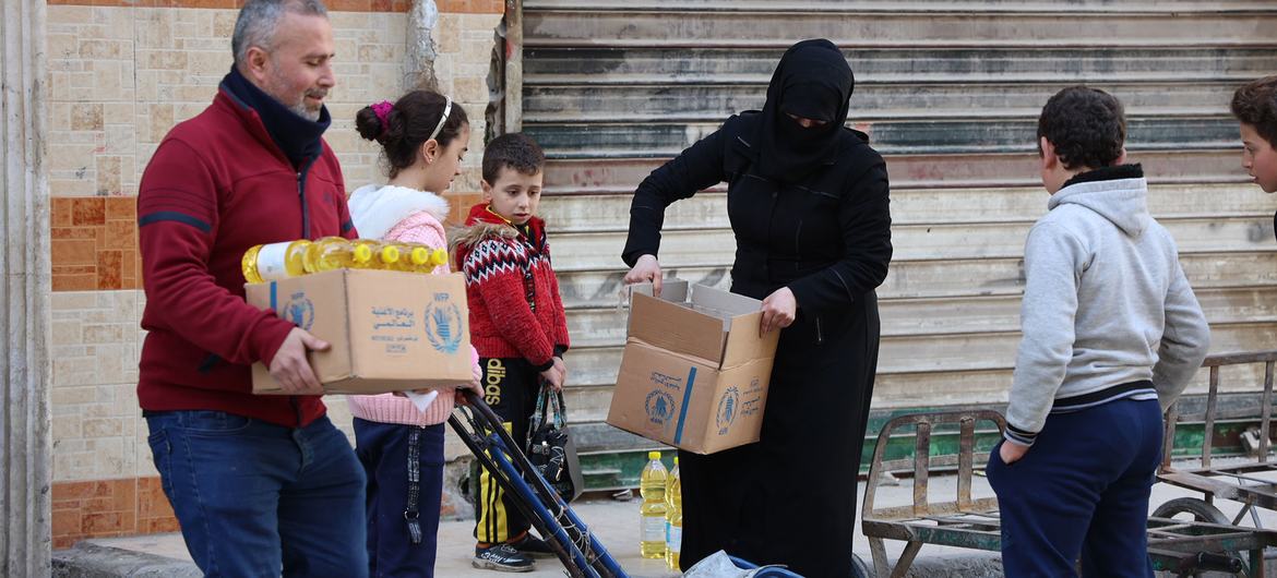 Alimentos para uso num mês são distribuídos para famílias deslocadas na área de Sukari, em Alepo, na Síria