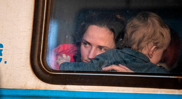 A mother and child leave Lviv's main train station in Ukraine. (file)