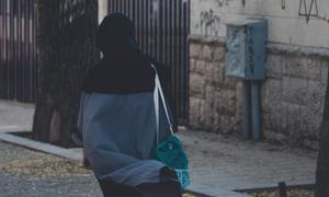 A woman in a hijab walks through the streets of Tehran, the Iranian capital.