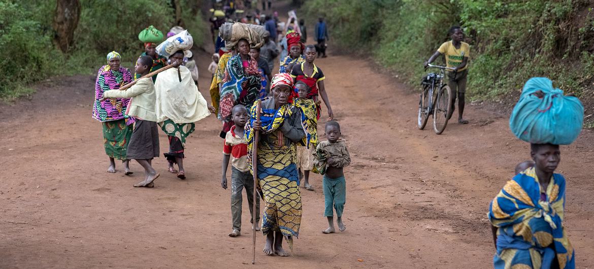 Displaced people walk back to Plain Savo site early morning after spending the night in host families in the nearby city of Bulé, in the Democratic Republic of Congo.