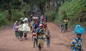 Displaced people walk back to Plain Savo site early morning after spending the night in host families in the nearby city of Bulé, in the Democratic Republic of Congo.