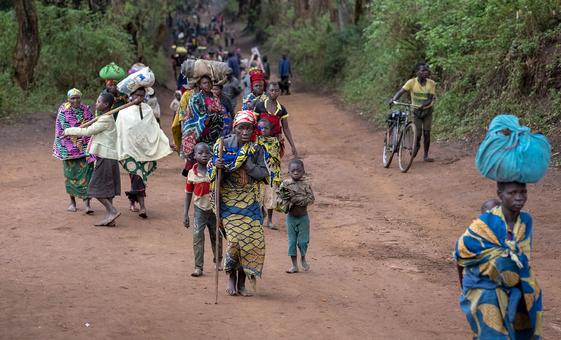 Displaced people walk back to Plain Savo site early morning after spending the night in host families in the nearby city of Bulé, in the Democratic Republic of Congo.