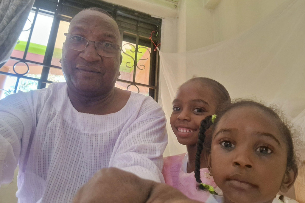 Adam with two of his daughters in Uganda. Adam with two of his daughters in Uganda.