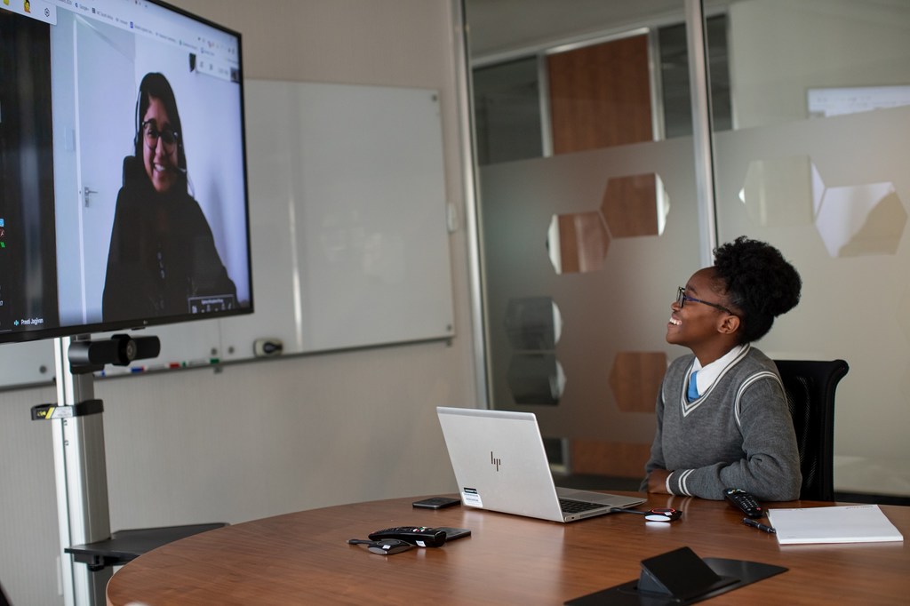 Sebabatso Nchephe (right), 18, chats remotely with her mentor, Pretty Jagivan (on screen) at Roche Pty Ltd's office in Sandton, South Africa. 