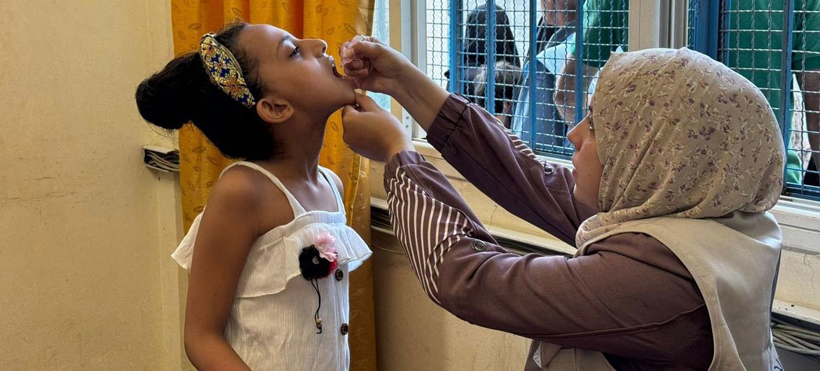 A child receives the polio vaccine in Gaza.