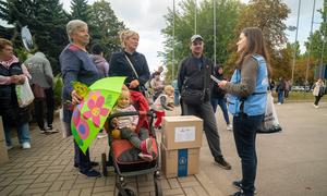 Viktoriya Hrubas (right) provides information to a family arriving at a humanitarian hub in Zaporizhzhia, after evacuating from Donetska Oblast in Ukraine.