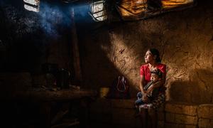 A mother and her son, who was suffering from malnutrition, sit in their home in Chiquimula, Guatemala.
