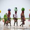 Unas mujeres cruzan una masa de agua en Rann, estado de Borno, Nigeria.