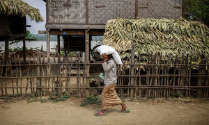 A woman carries a sack of fertilizer distributed by the UN in Yin Yane Village, Monywa, Myanmar. (file)