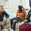 UNICEF Spokesperson James Elder speaks with 13-year-old Abu, who is injured, in a hospital room at Al Nau hospital in Khartoum, Sudan.