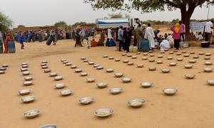 Families gather to have a meal prepared and provided by Zamzam camp emergency response room teams in North Darfur (file).