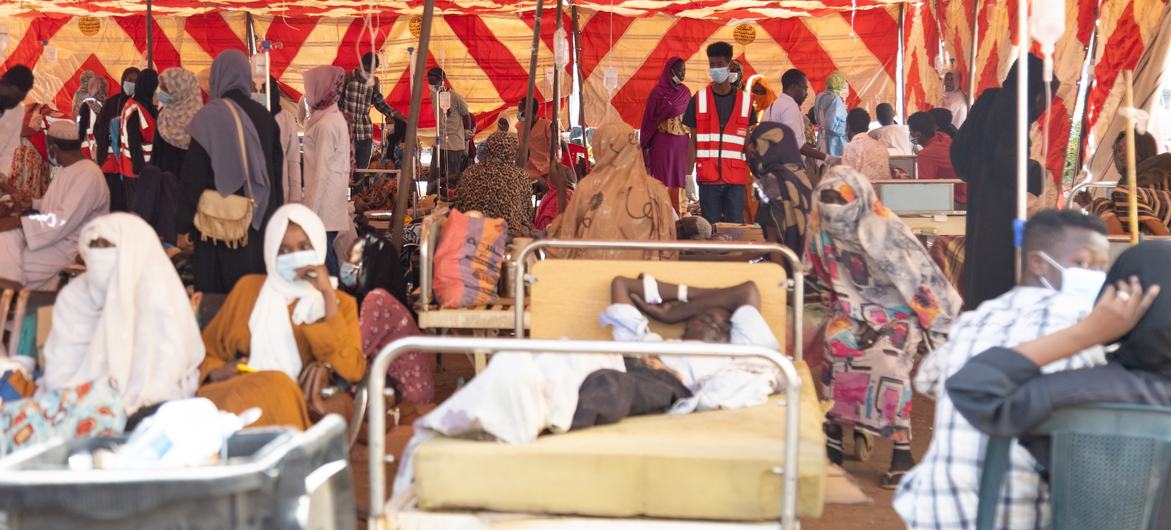 Patients receive treatment in a tent outside a hospital in Khartoum, as Sudan’s health system comes under severe strain from attacks, shortages, disease outbreaks, and natural disasters.
