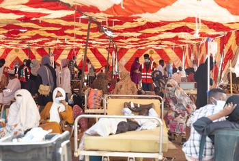 Patients receive treatment in a tent outside a hospital in Khartoum, as Sudan’s health system comes under severe strain from attacks, shortages, disease outbreaks, and natural disasters.