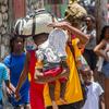Displaced by escalating violence, families in Haiti carry their belongings as they flee their homes in search of safety. 