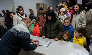 People in Ukraine receive winter coats at a UNICEF distribution point. (file)