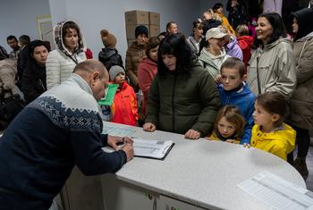 People in Ukraine receive winter coats at a UNICEF distribution point. (file)