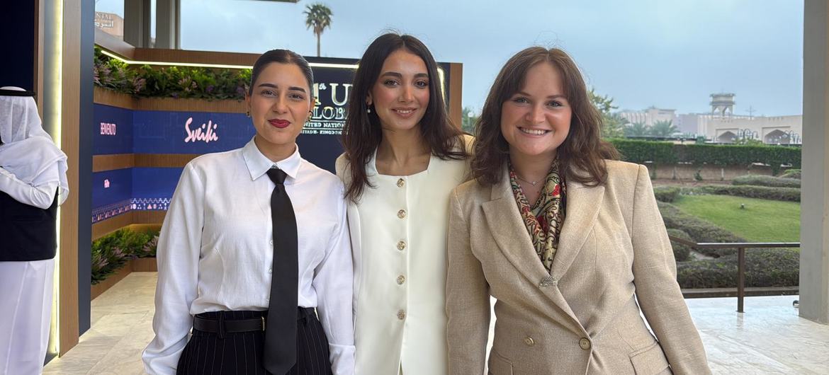 Three women posing for a photo at the UNAOC Riyadh Youth Forum, representing Georgia, Armenia, and Azerbaijan as part of the 2025 Young Peacebuilders programme.