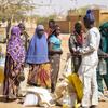 Displaced people wait in line for food distribution in Gorom-Gorom, Burkina Faso.