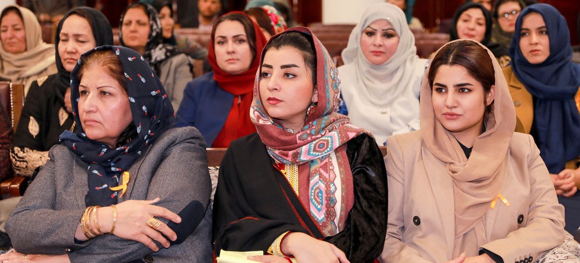 Afghan parliament members attend a meeting on women in decision-making roles.