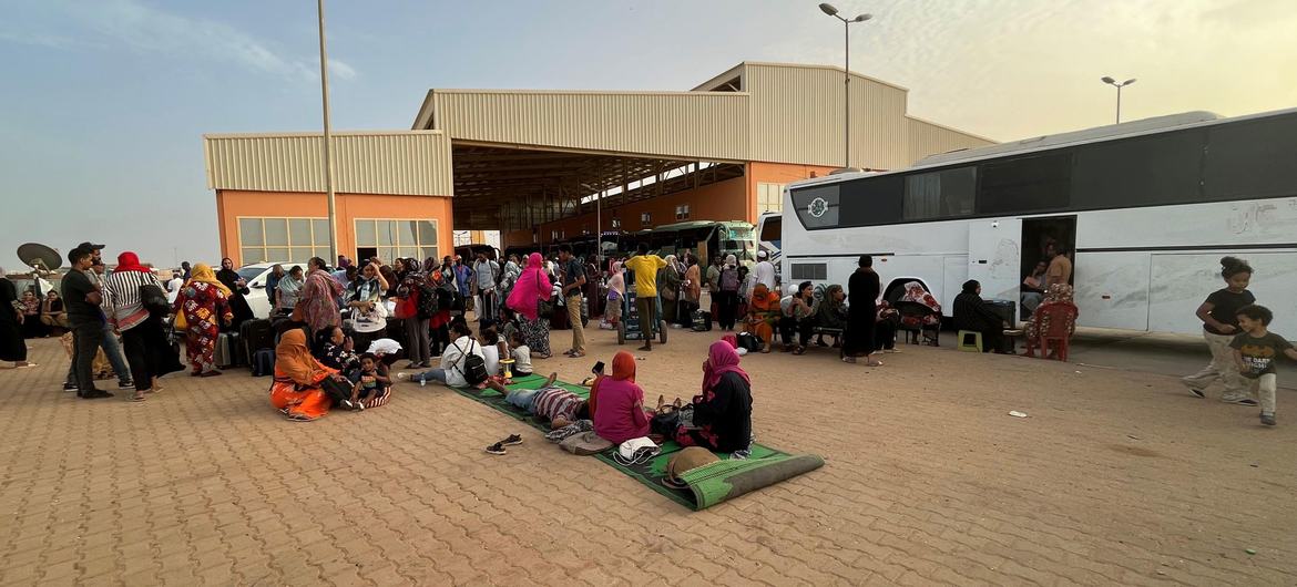 People fleeing conflict in Sudan wait at a bus station in Khartoum.