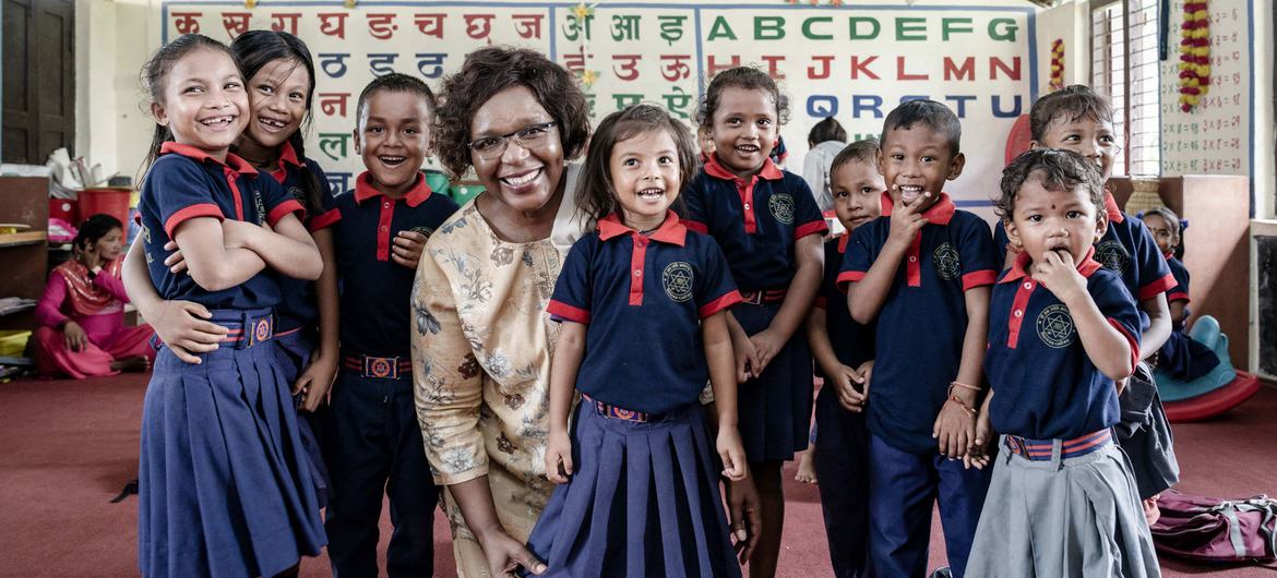 Alice Akunga, UNICEF Representative to Nepal, with a group of young children in a classroom. Alice Akunga, UNICEF Representative to Nepal, with a group of young children in a classroom.