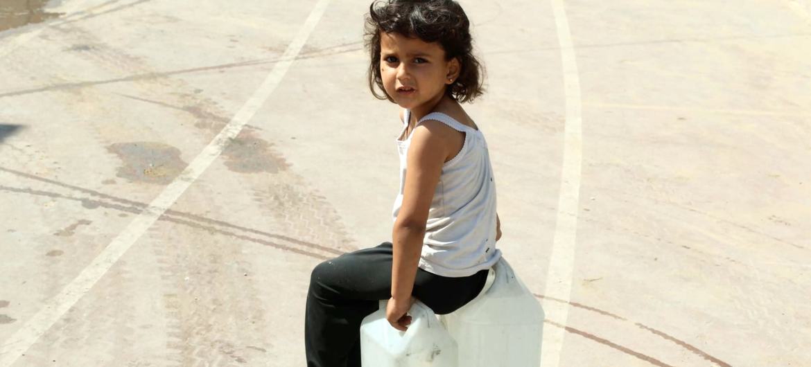 فتاة صغيرة تنتظر الحصول على مياه الشرب في غزة.