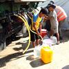 Children collect water from a truck in a displaced persons camp in Gaza. 