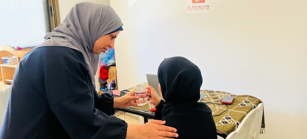 Salma, left, is a mother of four and gender-based violence case manager in Khan Younis. Salma, left, is a mother of four and gender-based violence case manager in Khan Younis.