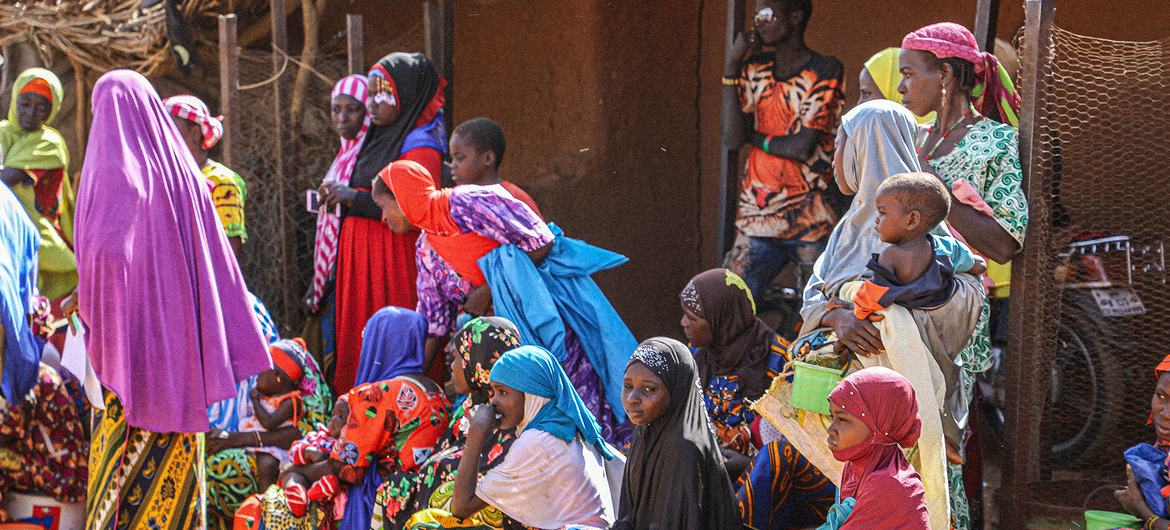 妇女和儿童在尼日尔塔瓦地区的粮食计划署分发处等待领取口粮。