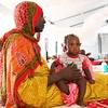 A Sudanese refugee receives care for her baby in the east of Chad