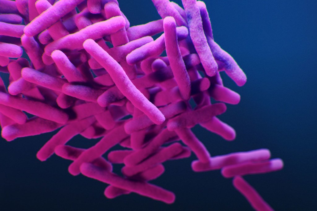 Mchoro wa kimatibabu wa bakteria sugu ya kifua kikuu cha Mycobacterium kwenye mandhari ya bluu nyeusi.