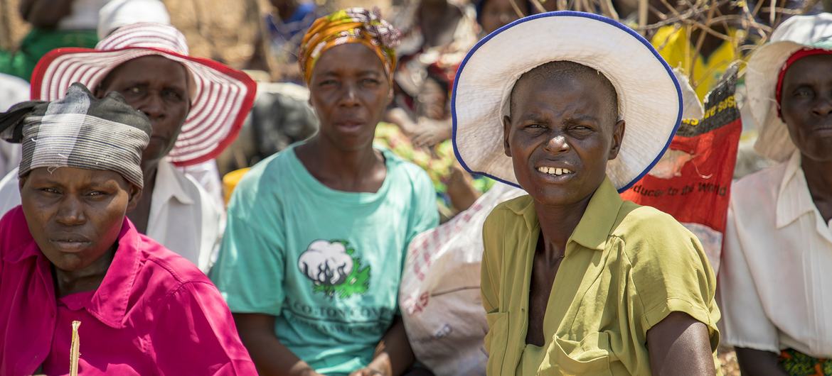 People wait for a distribution of food in Mazambara, Zimbabwe.