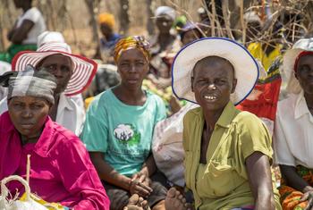 People wait for a distribution of food in Mazambara, Zimbabwe.