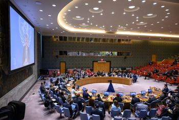 UN Security Council meeting in session, discussing the situation in the Middle East, with delegates seated around a large circular table in a formal chamber.