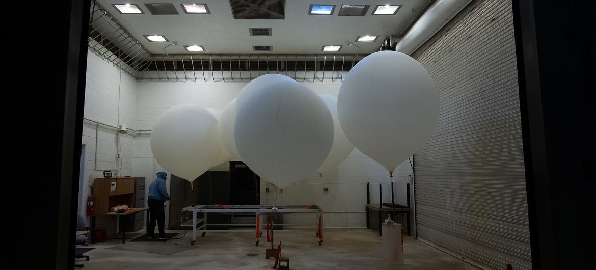 Weather balloons are prepared for release ahead of the launch of a NASA satellite.