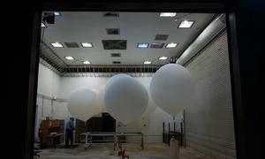 Weather balloons are prepared for release ahead of the launch of a NASA satellite.