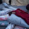 A child sleeps on relief items at a reception centre in Jandairis town in northern Syria.