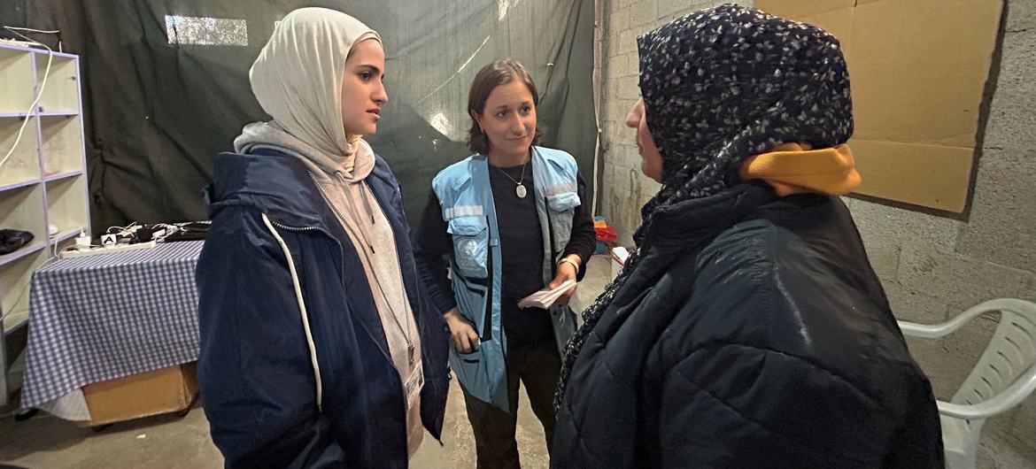 Yasmina Guerda, UN Humanitarian Affairs Officer (centre), talks with a Palestinian woman in Rafah, Gaza, in March 2024.