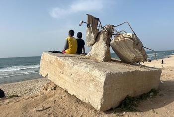 Two boys gaze out at the ocean at a beach, in Rafah, Gaza, April 2024.