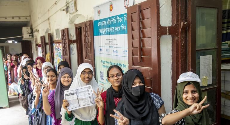 Girls between the ages of 10 and 14 are standing in a row to get the HPV vaccine at a girl high school in Bangladesh.