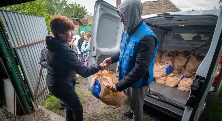A food package is delivered to a woman in  Ukraine.