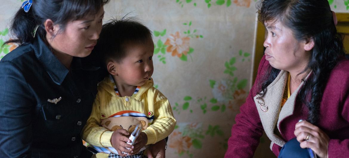 A healthcare worker visits a family in DPR Korea. (file)