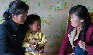 A healthcare worker visits a family in DPR Korea. (file)
