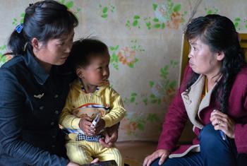 A healthcare worker visits a family in DPR Korea. (file)