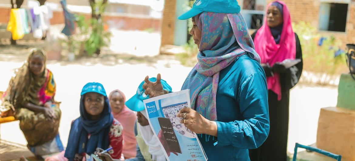 A UNICEF expert on sexual exploitation and abuse briefs displaced people at a gathering point in Wad Madani in east-central Sudan.