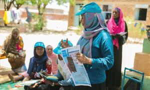 A UNICEF expert on sexual exploitation and abuse briefs displaced people at a gathering point in Wad Madani in east-central Sudan.