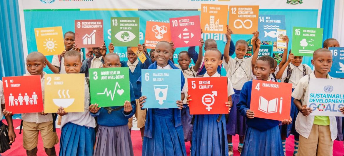 Estudiantes de Tanzania sujetan carteles con los Objetivos de Desarrollo Sostenible